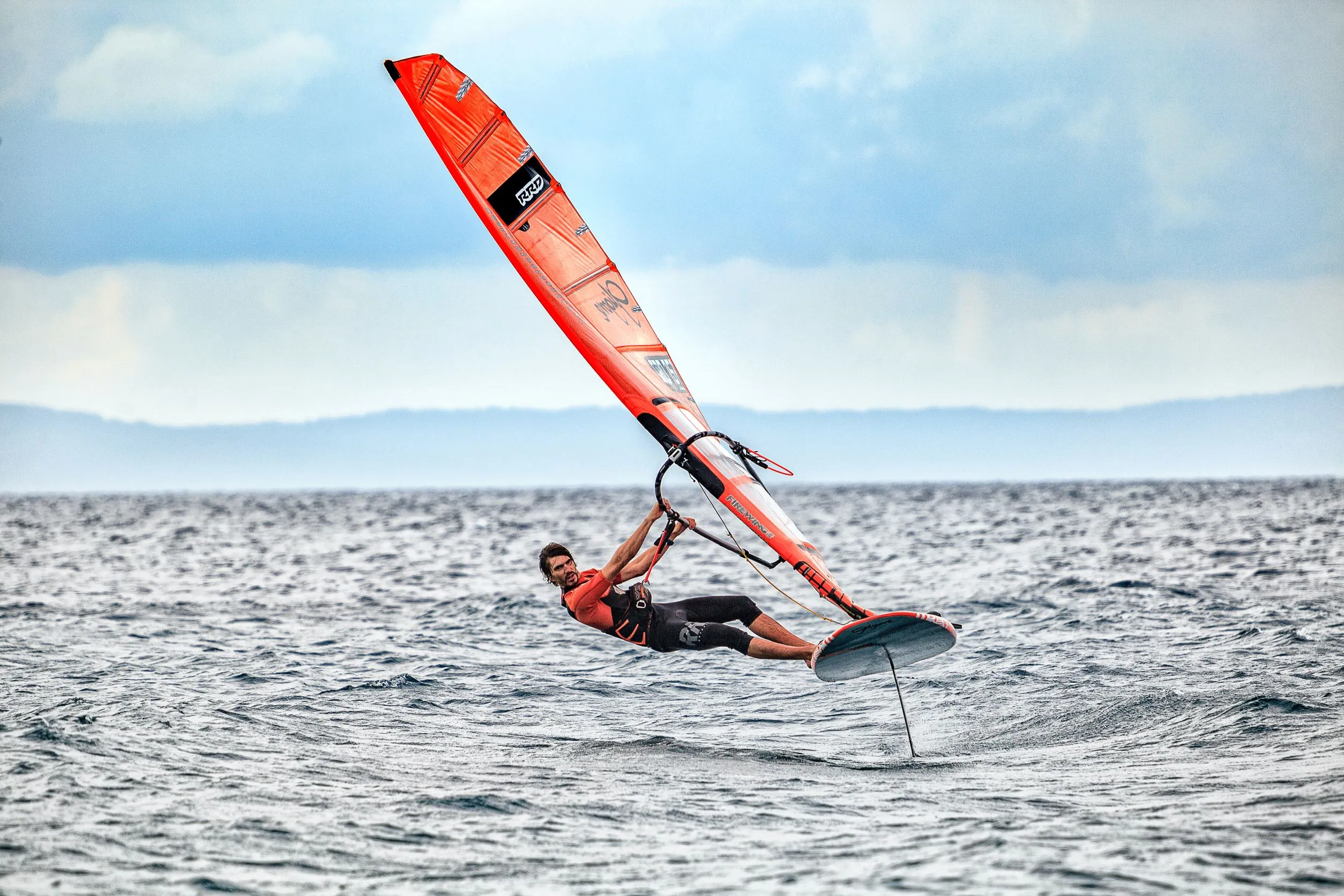 An agile windsurfer on the water