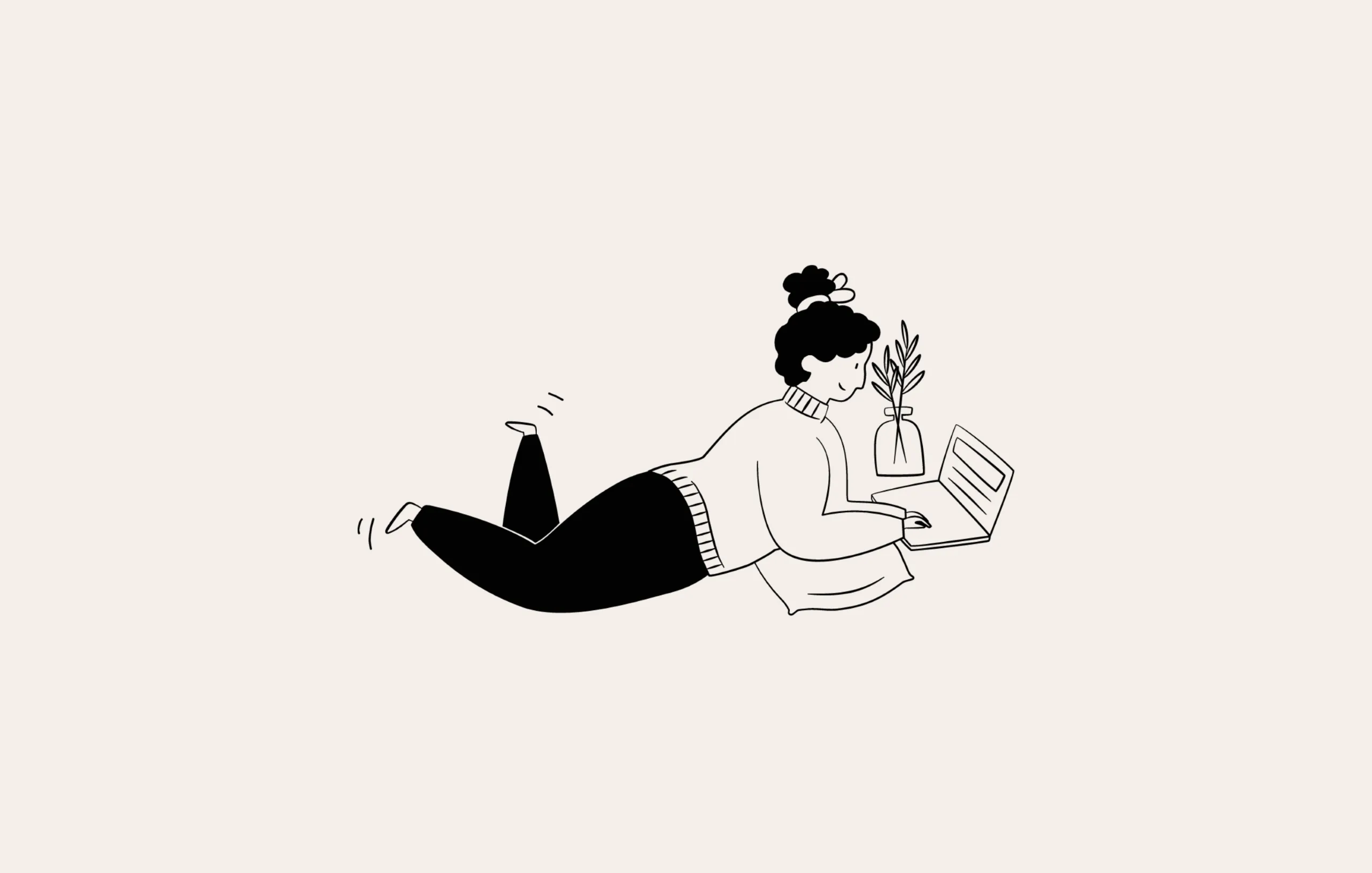 A person lying on the floor while working on her laptop